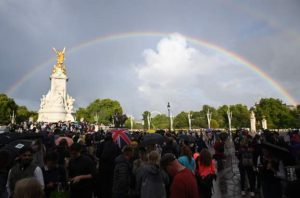Rainbow appears as people gather outside Buckingham Palace